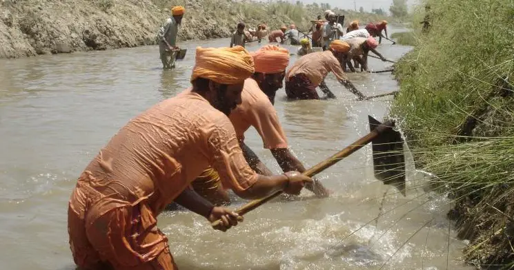 Sant Balbir Singh Seechewal Remove Trash and Plant Hyacinth Flowers Along Kali Bein River in India.